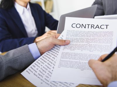 cropped image of businessman signing contract in office